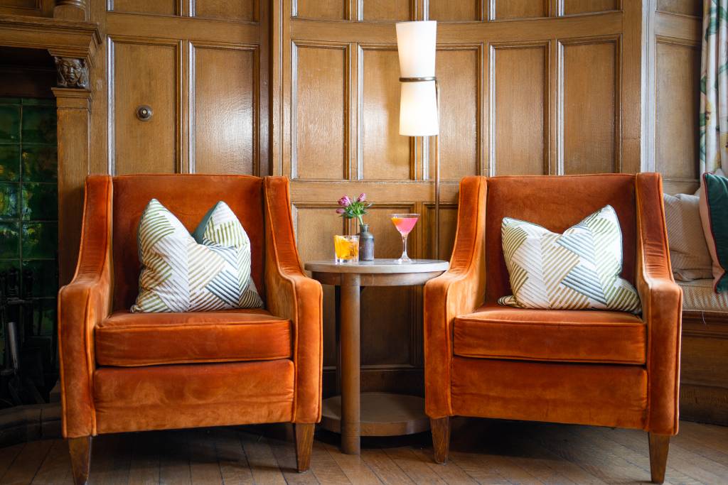 Cosy armchairs with cocktails on the coffee table in Cragwood's main hall